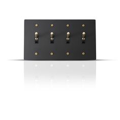 a black and gold switch plate with four lights on each side, in front of a white background