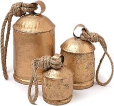 three antique brass canisters tied with rope