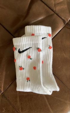 two pairs of white socks with roses on them