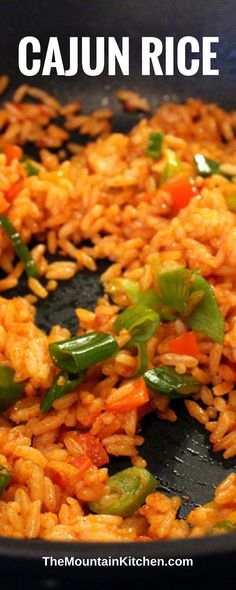 a close up of rice and vegetables in a pan with the words cajun rice above it