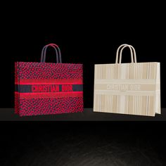 three different colored bags sitting next to each other on a black surface with the words christian dior printed on them