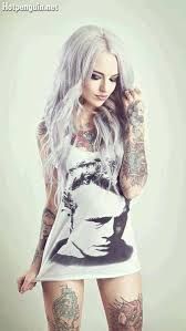 a woman with white hair and tattoos on her body