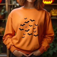 🦇 Vintage Bats Sweatshirt | Halloween Bats 🎃 | Vintage Halloween Sweater 👻 | Spooky Season 🦇 | Bat Gift Sweatshirt Description: 🎃 Get Spooky in Style! 🎃 Celebrate the spooky season with our Vintage Bats Sweatshirt--a perfect blend of eerie charm and cozy comfort. Featuring a timeless bat design 🦇, this sweatshirt captures the essence of vintage Halloween, making it a must-have for anyone who loves to celebrate in style. Features: 🦇 Vintage-Inspired Design: Show off your Halloween spirit Fall Costume Party Long Sleeve Tops, Long Sleeve Tops For Costume Party, Fall, Long Sleeve Tops For Costume Party In Fall, Spooky Orange Long Sleeve Tops, Orange Long Sleeve Spooky Top, Spooky Orange Crew Neck Top, Spooky Long Sleeve Halloween Tops, Spooky Long-sleeve Orange T-shirt, Spooky Long Sleeve Orange T-shirt