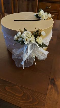 a wedding cake decorated with flowers and ribbons