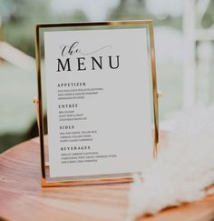 a menu card sitting on top of a wooden table next to a white fluffy ball