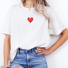 "Embrace LOVE with this classic minimalist heart tee! Made from 100% cotton in the USA, this unisex t-shirt showcases a charming small red heart at its core, embodying love throughout the year. With its simple yet captivating design, it effortlessly radiates affection wherever you wear it! Unisex Adult Sizing ensures a comfortable fit for all (If you prefer a loose fit go one size up. For the trendy oversized tee, consider 1-2 sizes up.) If you are unsure, simply measure your favorite tshirt on a flat surface and match to the size chart:-) Crafted with 100% USA-sourced Cotton for quality and sustainability - softer with every wash!  Exclusive Mac2u original design   Looking for the perfect gift? This 2024 artisan heart shirt says it all! Don't miss out on more exclusive designs, and stay t Matching Couple Shirts, Heart Tee, Heart Sweater, Embroidered Heart, Heart Shirt, Valentines Day Shirts, Heart Pattern, Valentines Shirt, Valentine Heart