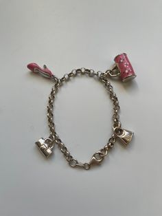 A vintage silver charm cable chain bracelet with 2 pink enamel charms and 2 silver charms. It is marked 925 and come with its original box. It has 4 charms in total: 1 is a pink high heel shoe with silver heel, 1 pink floral handbag with silver handle and flanks and two silver handbags. The whole length of the bracelet is 21cm and can be adjusted to fit any wrist size by click the lobster clasp onto any link of the silver cable chain. It is a piece of vintage jewellery but in a very good condition. No scratches and loss of enamels. Silver Charm Bracelet With Logo For Gift, Silver Charm Bracelet With Logo As Gift, Pink Jewelry With Logo Charm For Gifts, Pink Metal Charm Bracelet With Charms, Pink Metal Charm Bracelet With Removable Charms, Pink Metal Charm Bracelet, Pink Sterling Silver Charm Bracelet With Dangling Charms, Sterling Silver Pink Charm Bracelet With Dangling Charms, Pink Metal Charms With Lobster Clasp