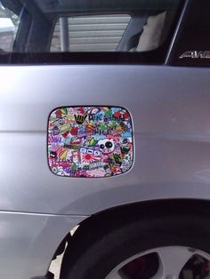 stickers on the side of a silver car