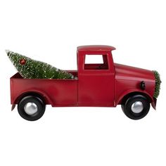 a red truck with a christmas tree in the back