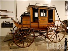 an old fashioned horse drawn carriage on display