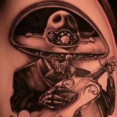 a man with a hat and guitar tattoo on his stomach is holding an acoustic instrument