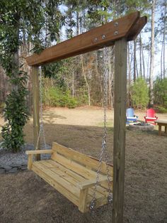 a wooden swing with chains hanging from it