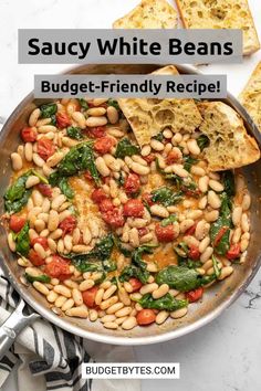 a skillet filled with beans and spinach next to slices of toasted bread