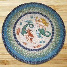 a blue and green plate with mermaids on it