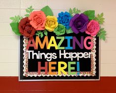 a sign that says amazing things happen here with paper flowers on the front and sides