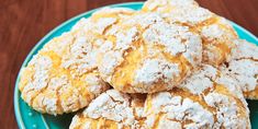 some powdered sugar cookies on a blue plate