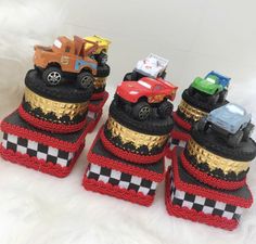 four toy cars are stacked on top of each other