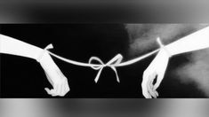 black and white photograph of two hands tied up