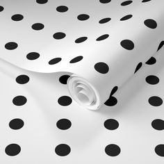 black and white polka dot wallpaper on a white surface with an oval design in the center