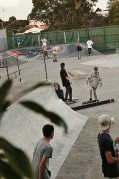 several skateboarders are at the top of a ramp