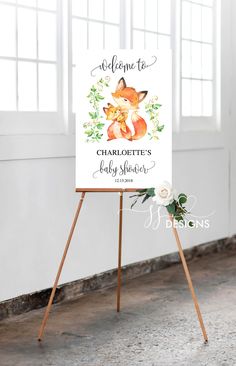 a welcome sign for a baby shower with an image of a fox and flowers on it