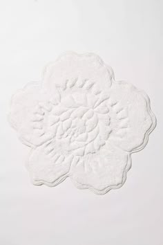 a white doily with a flower design on it