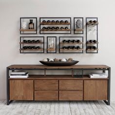 a wooden table topped with lots of shelves filled with bottles and bowls on top of it