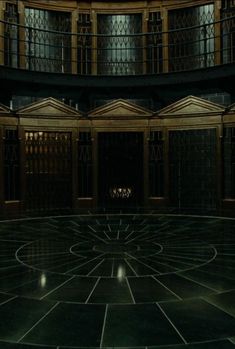 an empty room with many doors and windows in the center is lit up at night