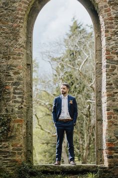 a man standing in front of an old window