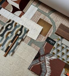 an assortment of rugs, including one with a wooden stick in the middle and another with fabric on it