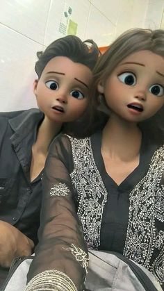 two dolls that are sitting next to each other