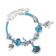 a blue bracelet with charms and charms on the clasp, featuring an ocean themed charm