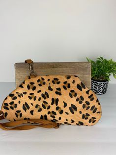 Genuine leather Leopard print clutch with long strap. Wooden handle 9 inches in length. Brown Leather Satchel Clutch With Handles, Brown Top Handle Clutch For Daily Use, Brown Leather Clutch With Detachable Handle, Leather Handheld Clutch For On-the-go, Handheld Leather Clutch For On-the-go, Brown Clutch With Removable Pouch For On-the-go, Brown Top Handle Clutch For Everyday Use, Brown Clutch With Leather Handles For Daily Use, Brown Leather Handle Clutch For Daily Use