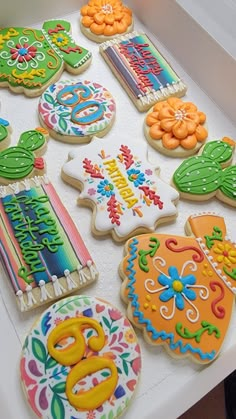 decorated cookies are displayed on a table