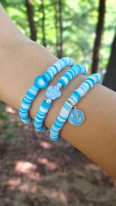 This super cute clay bead bracelet is made with high quality beads. It has a randomized pattern with the colors: -blue -light blue -white The first bracelet to choose from has a gradient heart bead in the center. The second bracelet has a blue flower bead with 2 pearl beads. lastly, you can choose a dangling blue smiley face. Like this design but want a differnt charm? Check out the rest of my Etsy store to find this same bracelet design but with differnt charms. Please note that colors and pattern may vary from each bracelet. All bracelets vary from 6.5 inches to 6.75 inches.  While the string I use is high quality, be careful not to overstretch the bracelet as it will shorten its lifespan. In addition, keep out of water as it will shorten the lifespan of the bracelet. Excessive sweating Playful Blue Beaded Bracelets As Gift, Playful Blue Beaded Bracelets For Gifts, Playful Blue Friendship Bracelets With Colorful Beads, Fun Blue Beaded Bracelets For Gifts, Playful Blue Beaded Bracelets For Gift, Trendy Blue Heart-shaped Bracelet, Casual Blue Jewelry With Heart Beads, Blue Heart Beads Friendship Bracelets For Beach, Handmade Blue Friendship Bracelets Playful Style