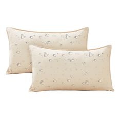 two pillows with water drops on them, one is white and the other is beige