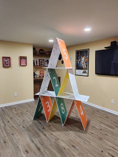 a room with wooden floors and an upside down shelf in the shape of a triangle