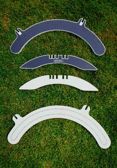 three different types of blades laying on the grass