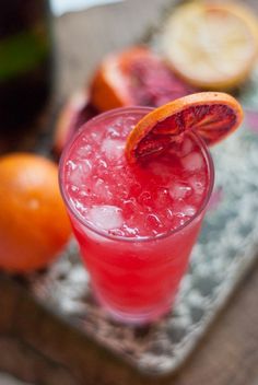 an orange slice on top of a drink in a glass