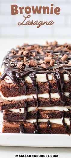 brownie lasagna with chocolate drizzle on top and white icing