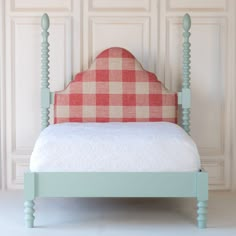 a bed with a checkered upholstered headboard and foot board is shown