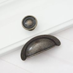 an old door handle and knob on a white cabinet