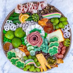 a platter filled with lots of different types of food and snacks on top of it