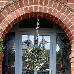 a blue front door with a wreath hanging on it