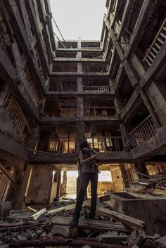 a man standing in the middle of an abandoned building