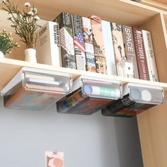 the bookshelf is full of books and magazines