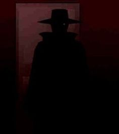 the silhouette of a man wearing a hat and cloak in front of a red wall