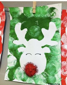 handprinted reindeer art project for kids on clothes line with red and green paper