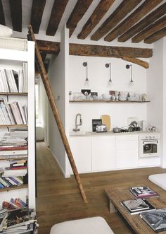 a living room filled with furniture and books