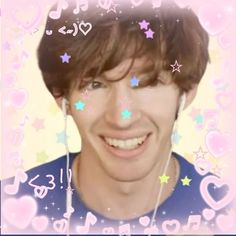 an image of a man with headphones on smiling at the camera and surrounded by hearts and stars